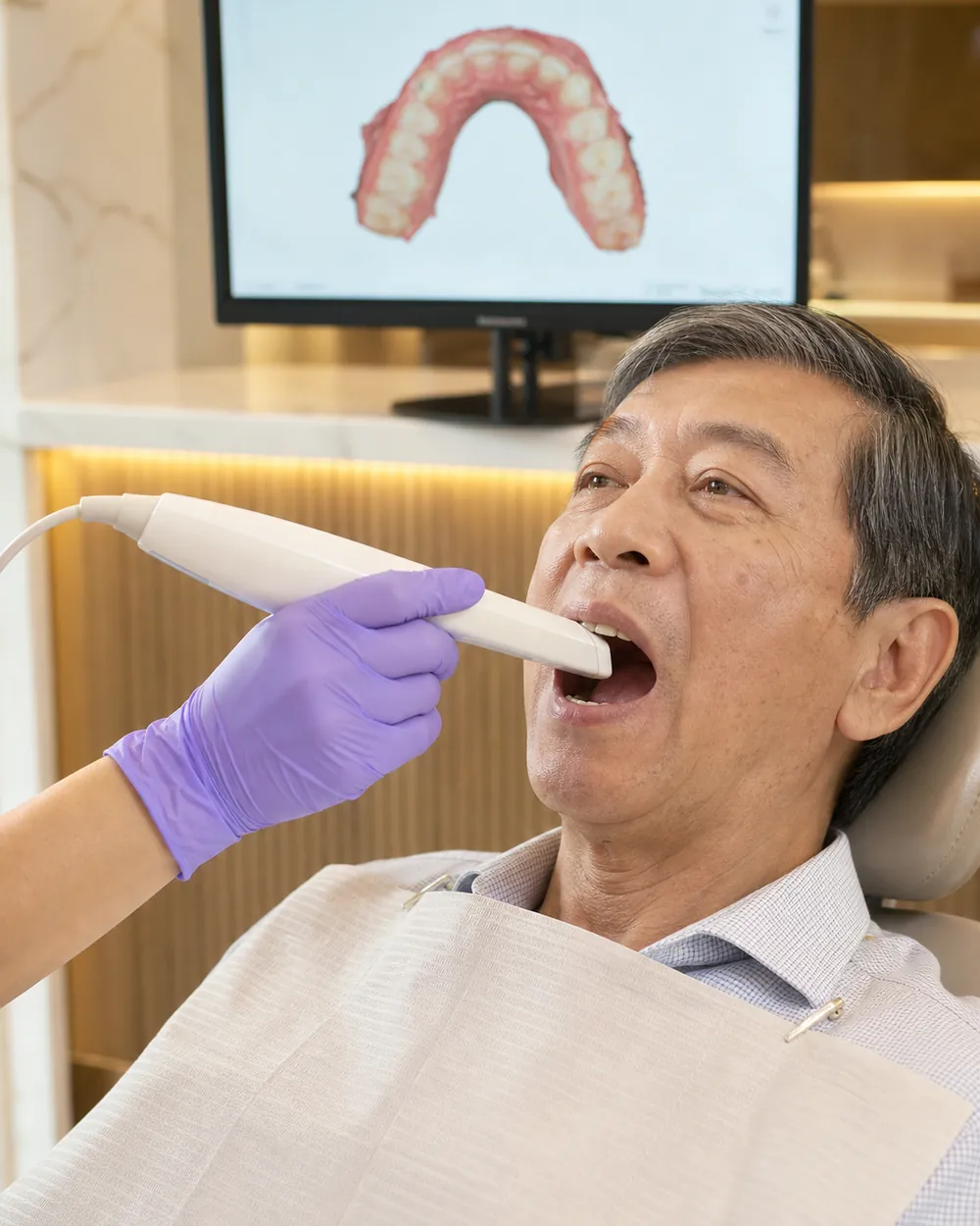 Dentist using a digital intraoral scanner to plan Invisalign treatment